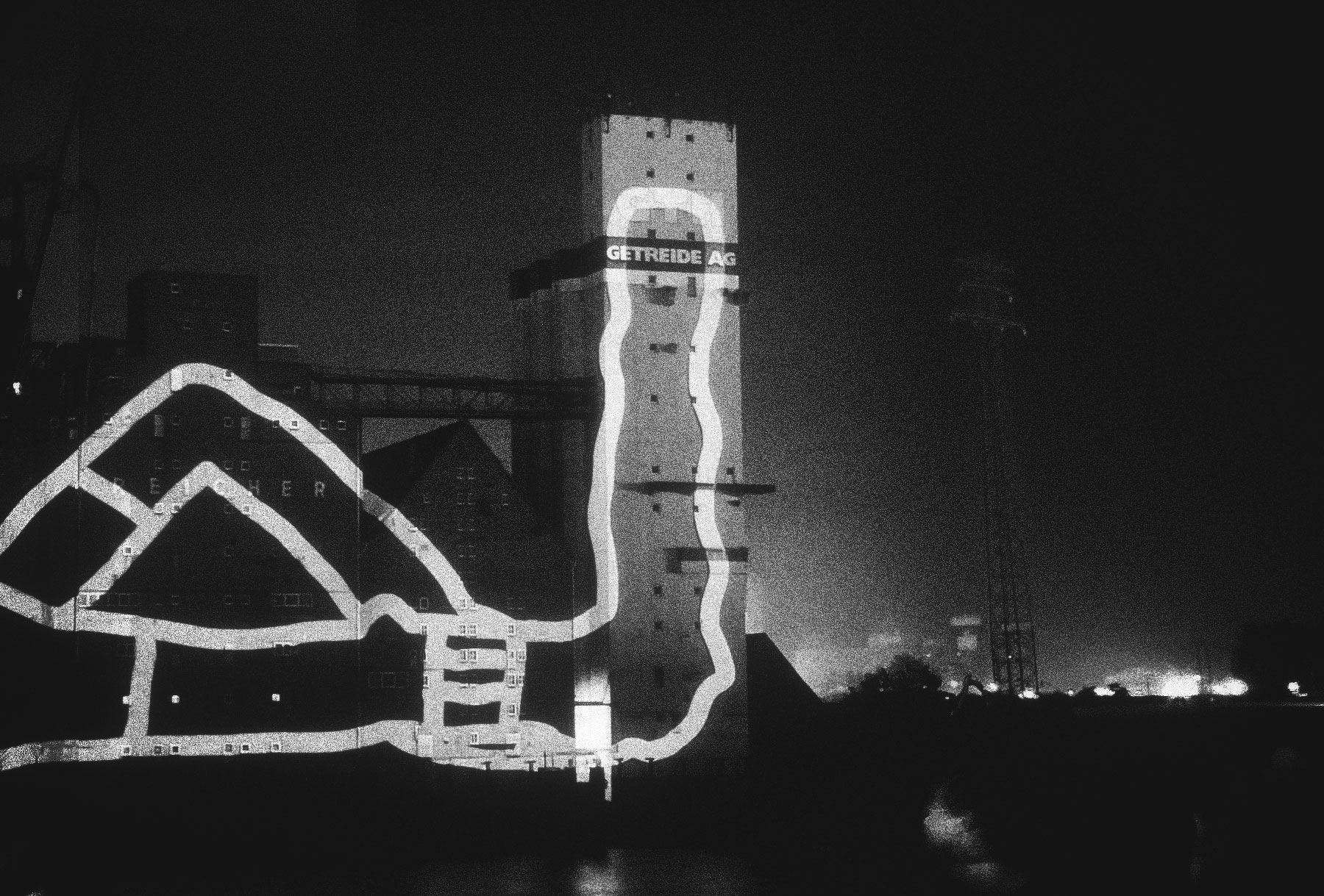 A huge drawn sock is projected onto a building